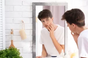 teenage boy with bad acne habits